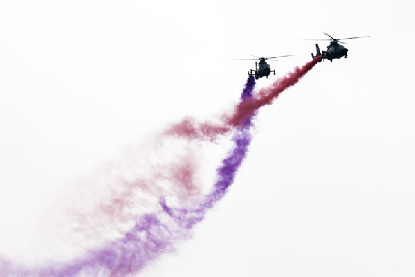 Helicopters practice acrobatic moves for expo