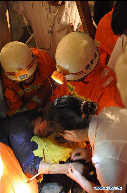 Rescuers search for trapped people at landslide site in Guizhou