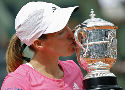 Belgium's Justine Henin kisses her trophy after defeating Serbia's Ana Ivanovic in the women's final match at the French Open tennis tournament at Roland Garros in Paris June 9, 2007.