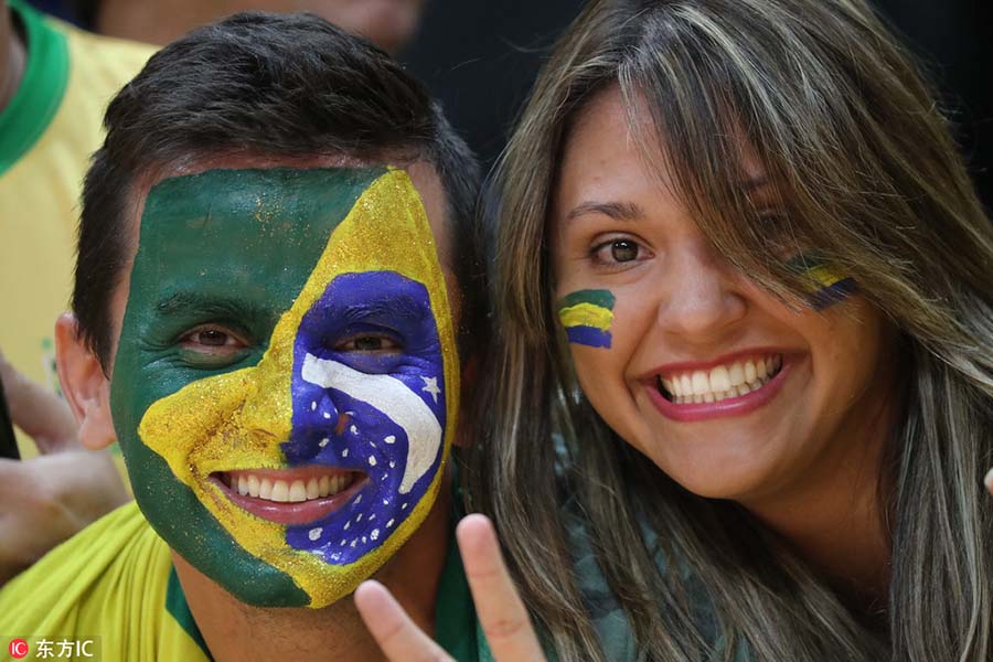 Fans with face paint celebrate Olympics