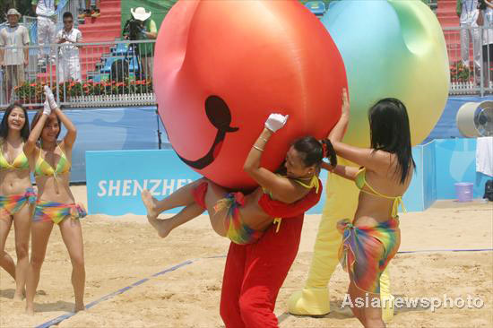 Cheerleaders light up beach volleyball court