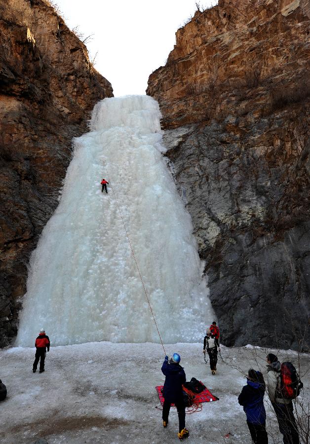 Tourists do ice climbing on frozen waterfall in suburb of Beijing