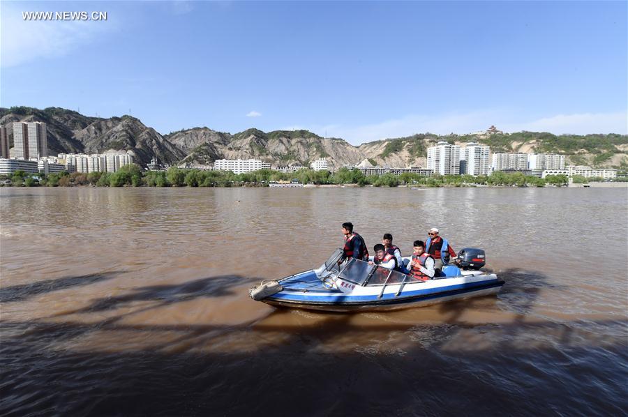 Tourists take sightseeing speedboat on Yellow River in China's Lanzhou