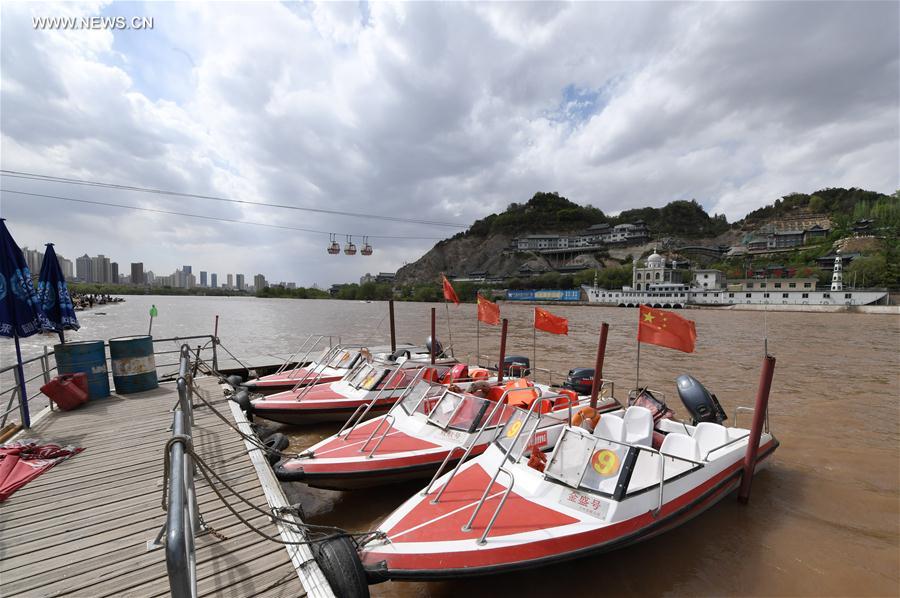 Tourists take sightseeing speedboat on Yellow River in China's Lanzhou