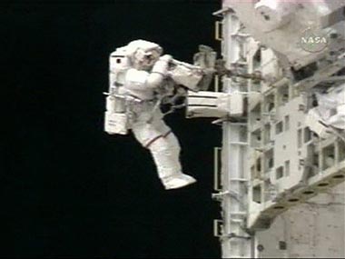 In this image made from NASA TV, astronaut Piers Sellers gathers tools on the outside of the International Space Station during a spacewalk Monday, July 10, 2006. ( AP Photo