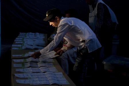 Workers start to count election votes in Afghanistan