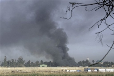 Smoke rises from the US protected Green Zone in central Baghdad, Iraq, Sunday, March 23, 2008, after it was targeted by a series of rockets or mortars. A random shooting incident killed seven people and injured 16 others in southern Baghdad on Sunday, a well-informed police source said. [Agencies]