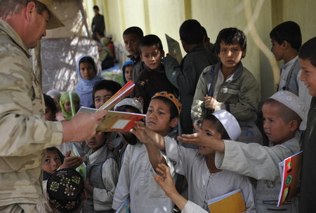 Afghan school continues as soldiers guard aside