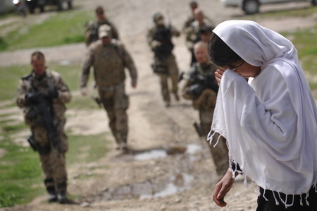 Afghan school continues as soldiers guard aside